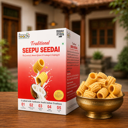 A box of Traditional Seepu Seedai snack crackers stands on a wooden table outdoors, with a brass bowl of the golden-yellow rolled crackers placed beside it. The packaging is predominantly white and red with product imagery and text, and the background shows a softly blurred traditional building and greenery.