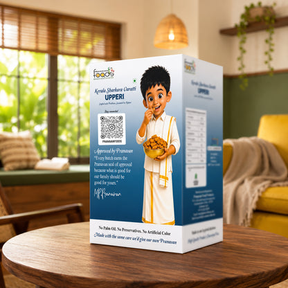A boxed food product labeled 'Agenda sharkara varatti UPPERi' stands on a wooden table in a real indoor living-room setting with a sofa, lamp, and windows in the background. The box is predominantly white and blue with a cartoon boy in white clothing holding a bowl of sharkara varatti upperi, and several text blocks and a QR code on the front.