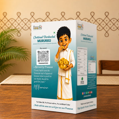 A boxed food product labeled 'Chettinad Thenkazhal Murukku' stands on a wooden table in a real indoor setting with a plant and wall decor visible. The package is predominantly white and teal with printed branding, a QR code, and an illustrated child holding a bowl of golden-brown snacks.