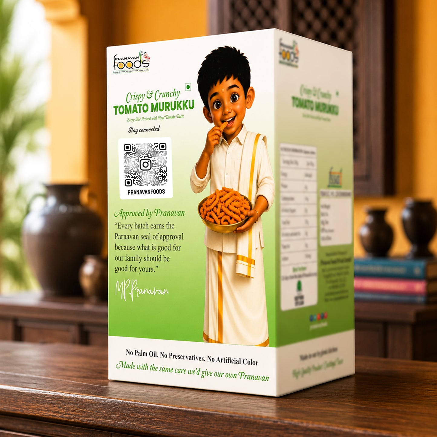 A boxed food product labeled 'Tomato Murukku' stands on a wooden surface in an indoor setting. The package is predominantly white and green, with printed text and a cartoon illustration of a boy holding a plate of fried snacks.