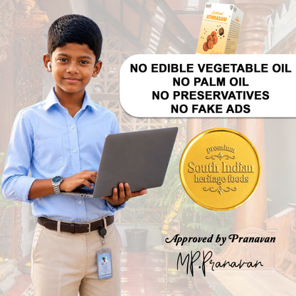 A promotional graphic featuring a young boy in a light blue shirt and beige trousers holding a laptop, with a small box of South Indian Heritage Foods product shown at the top right. Large text reads 'NO EDIBLE VEGETABLE OIL NO PALM OIL NO PRESERVATIVES NO FAKE ADS,' alongside a gold seal and the approval signature 'Approved by Pranavan MP.